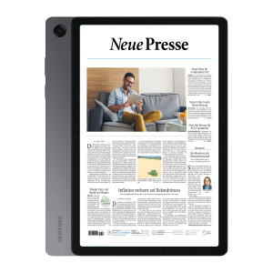 Tablet showing a newspaper layout titled 'Neue Presse' on a screen, with a man reading on a gray sofa in a living room.